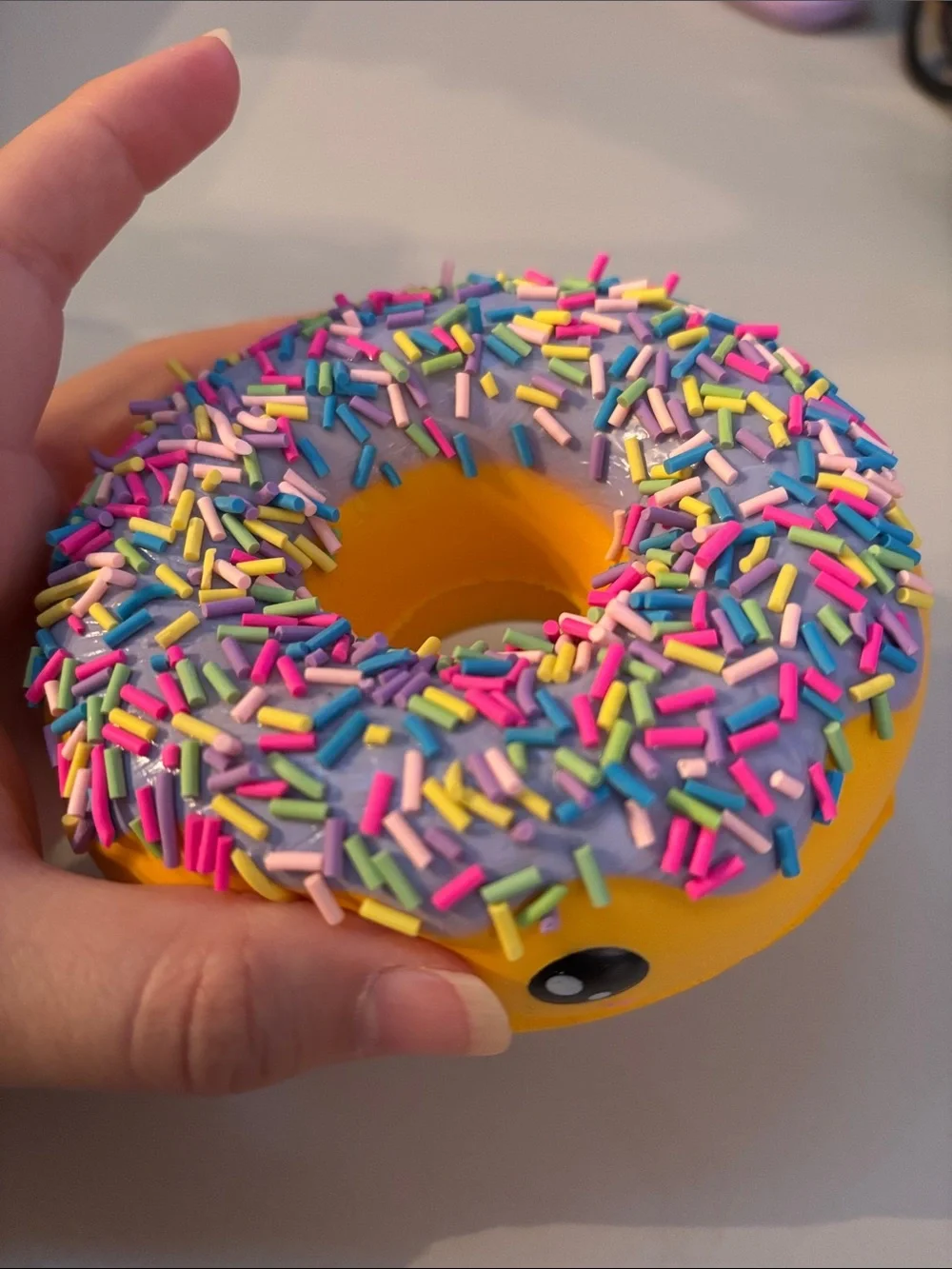 Smiling Yellow Donut Plush Toy with Purple Frosting and Rainbow Sprinkles